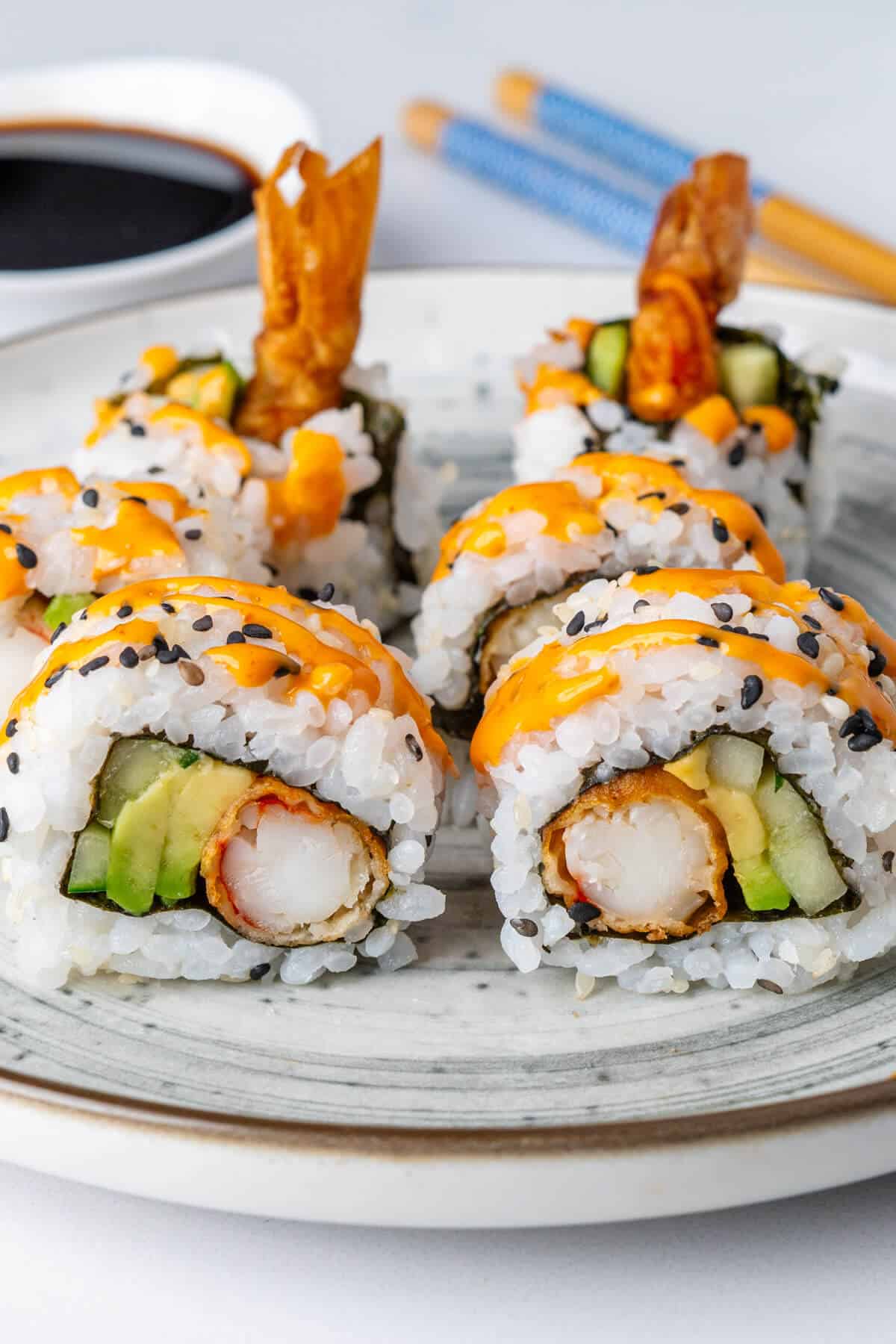 Shrimp tempura roll topped with sriracha mayo