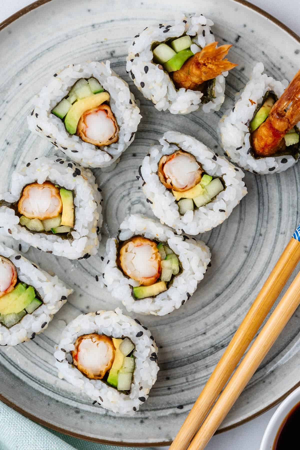 Shrimp tempura roll cut in pieces on a plate