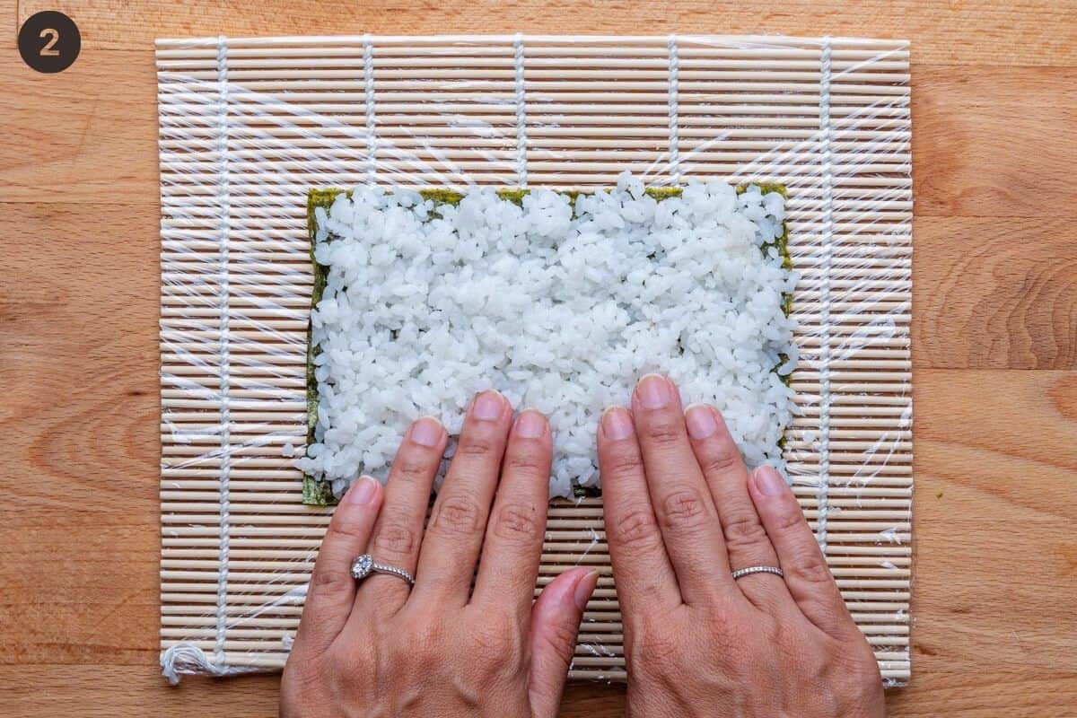 Rice add to nori sheet with fingers