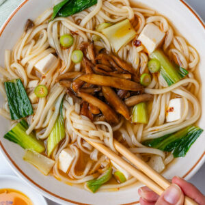 Udon noodle soup with miso broth in a bowl with chopsticks