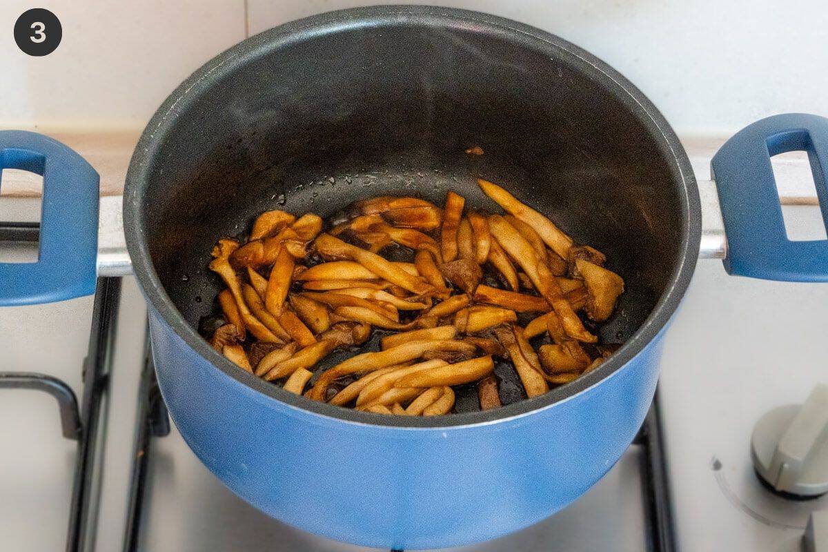 Mushrooms being sautéed in a pot