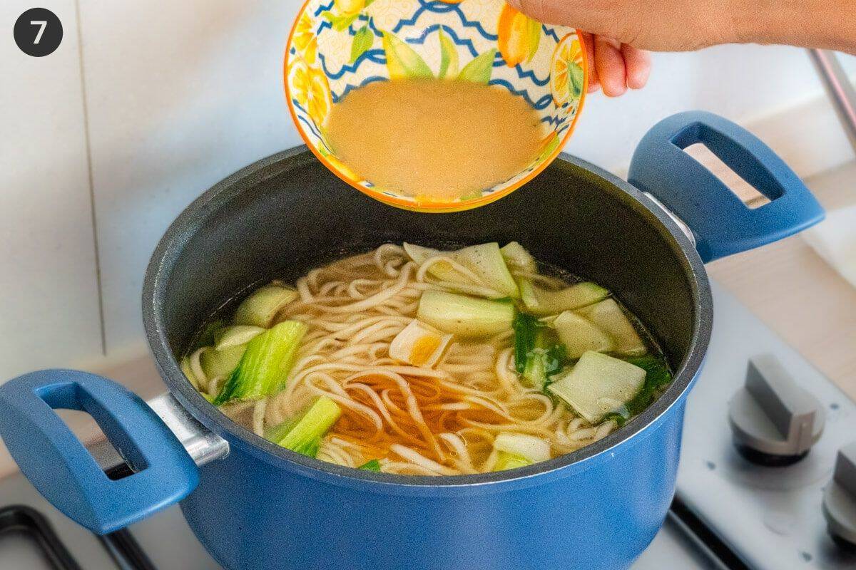 Miso paste being added in large pot