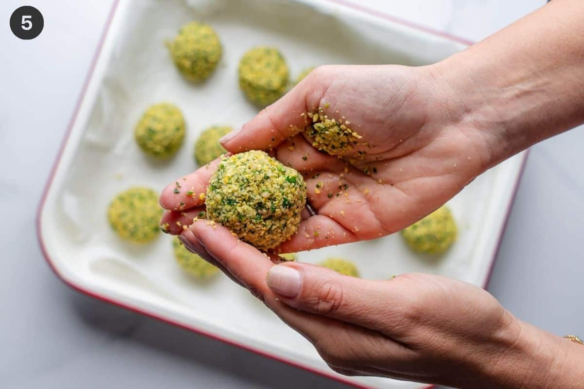 Falafel balls being shaped in hands