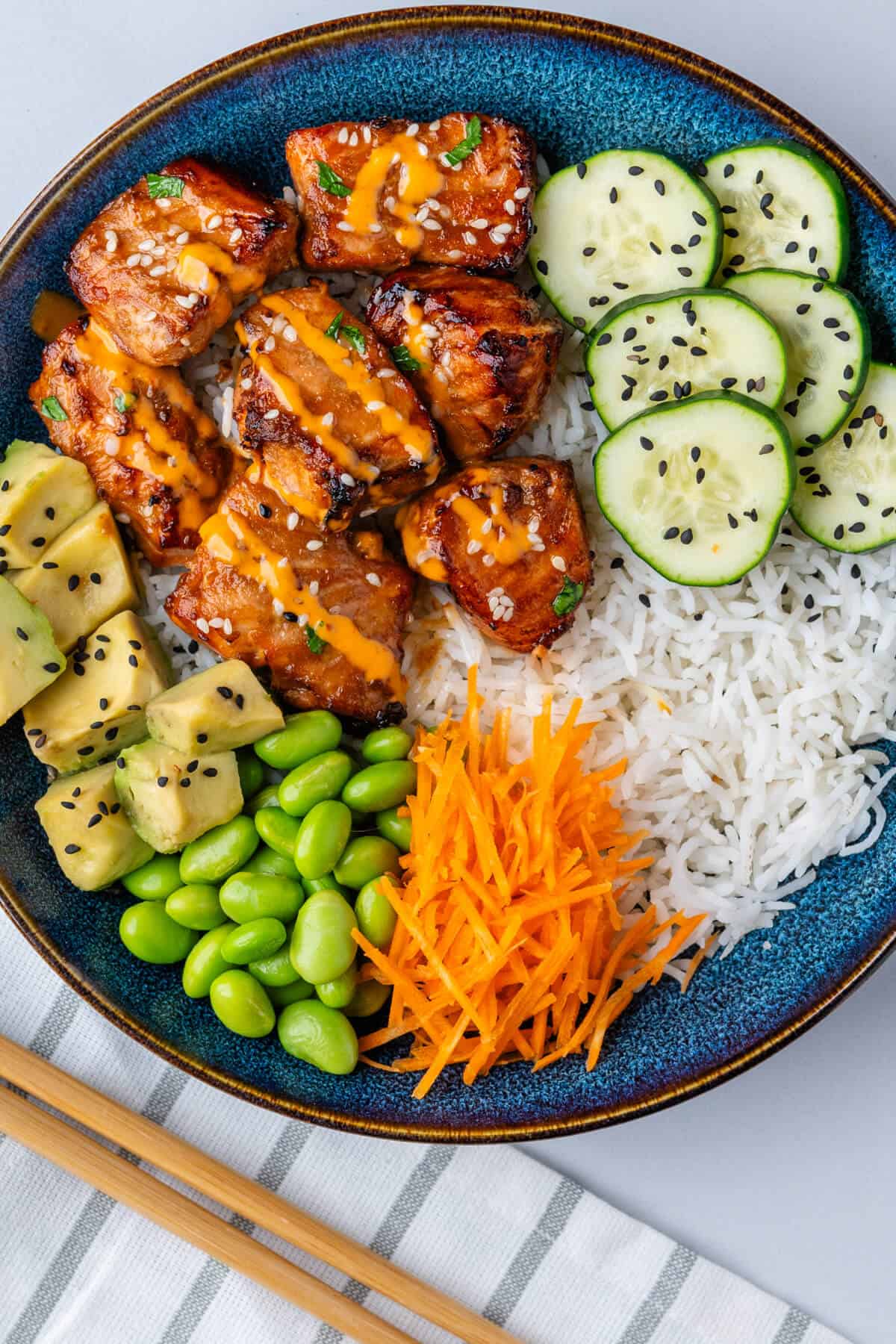 Salmon bowl with rice, veggies, avocado and edamame beans