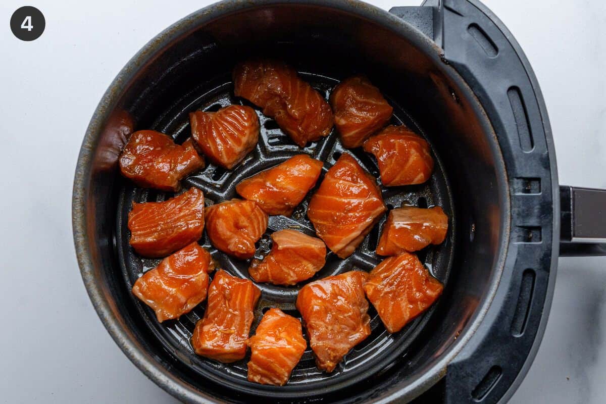 Salmon pieces placed in air fryer basket