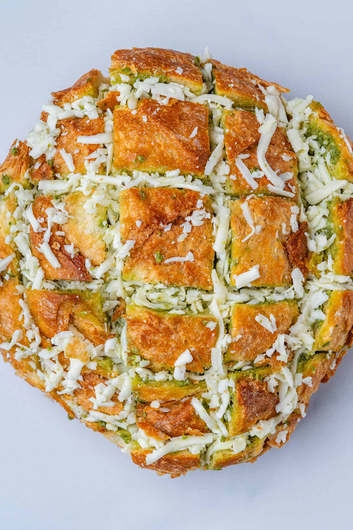 Bread stuffed with cheese and pesto before being baked