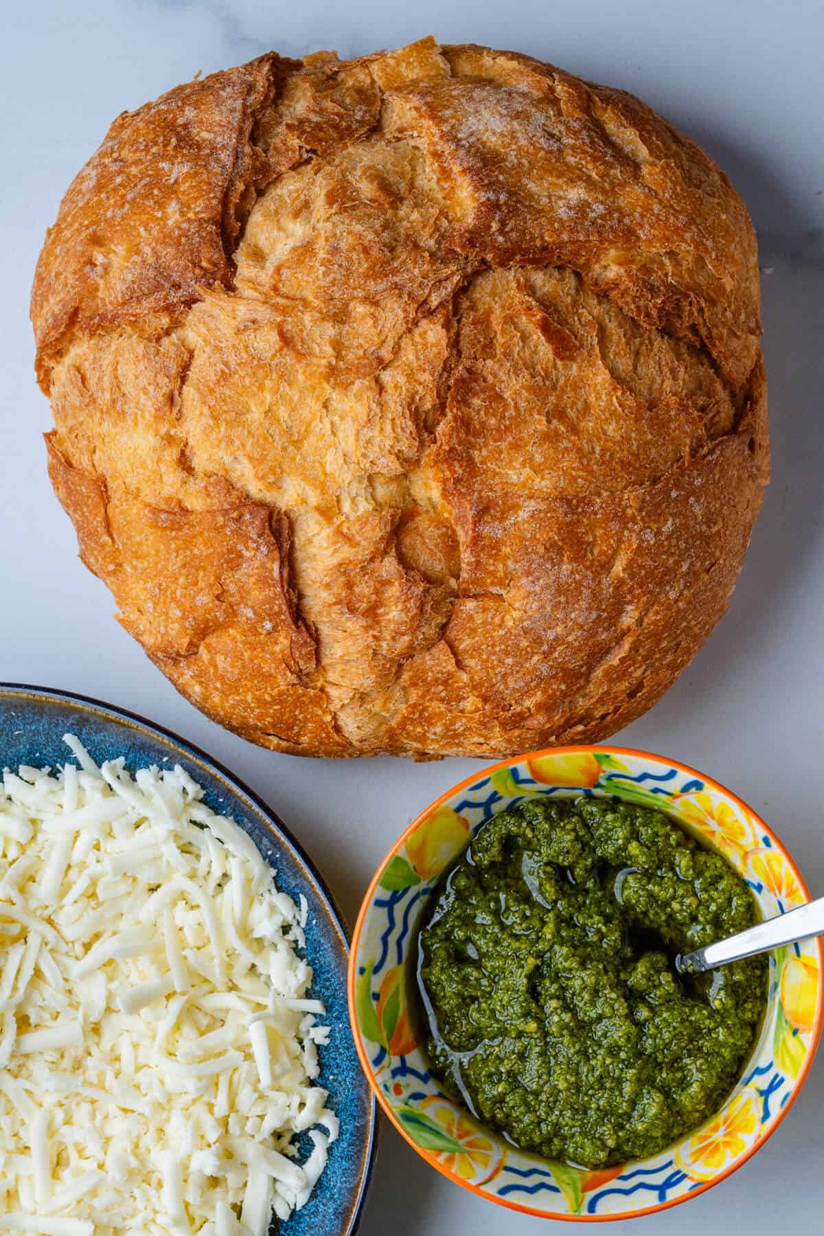 Ingredients of bread loaf, mozzarella and pesto