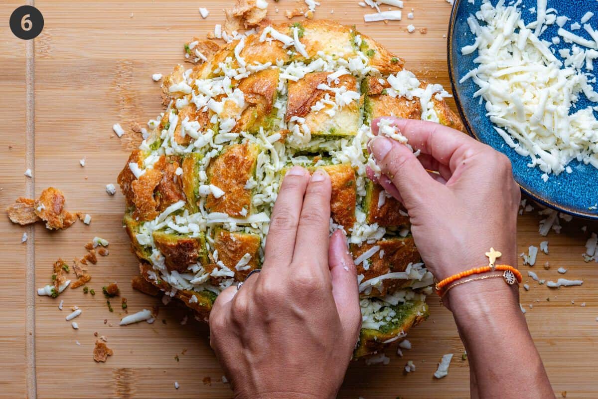 Shredded mozzarella being stuffed into bread