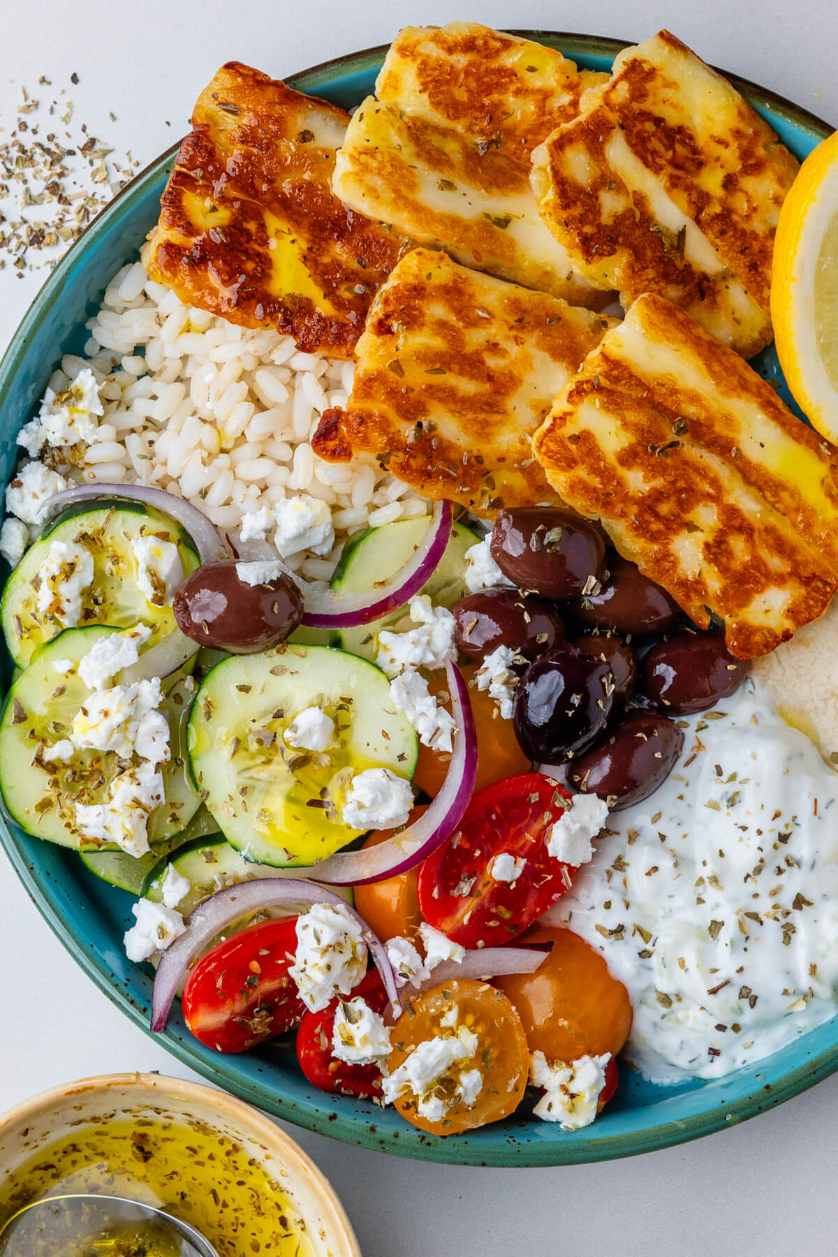 Greek bowls with halloumi, veggies, pita bread and tzatziki