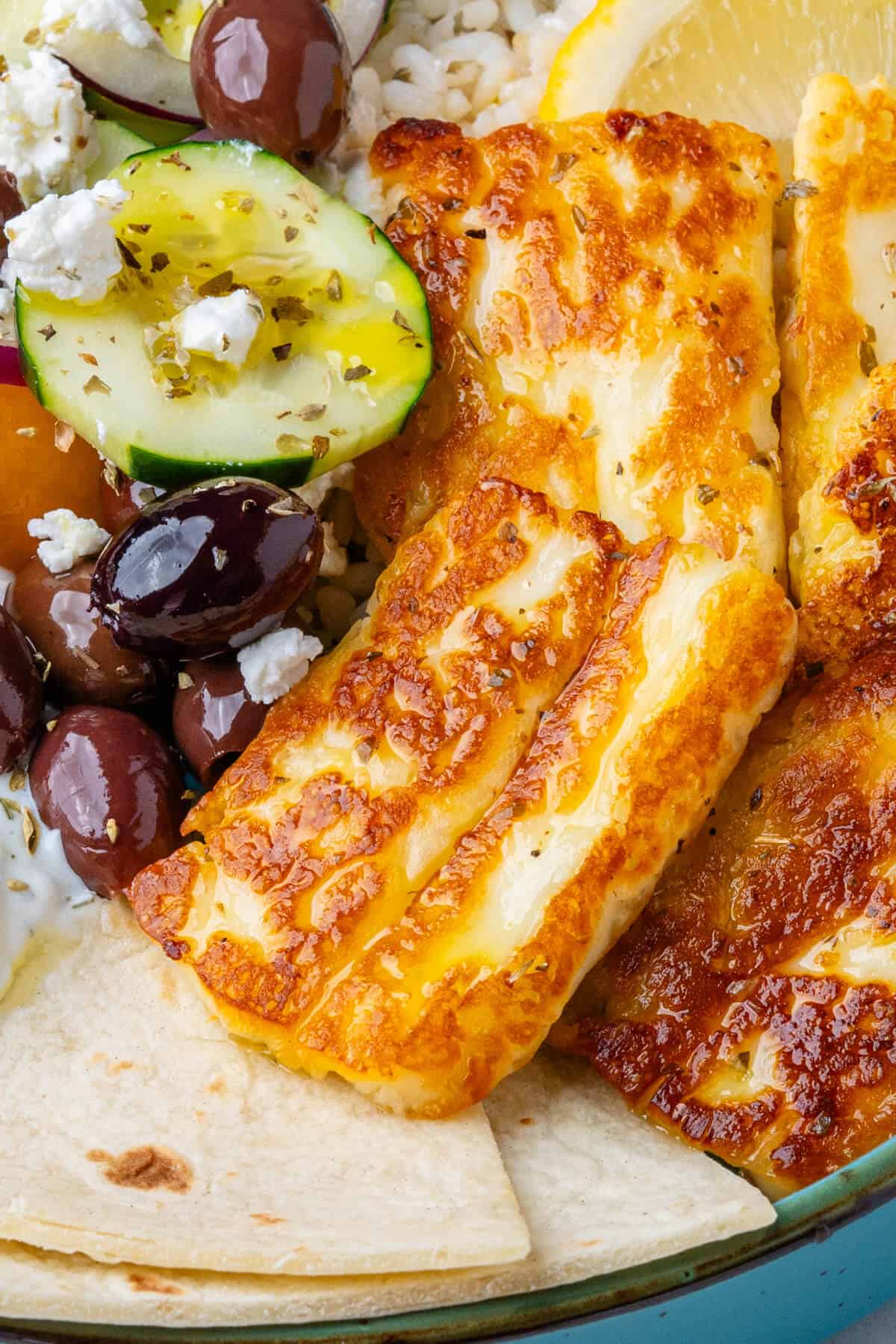 Close up of halloumi and olives in a greek bowl