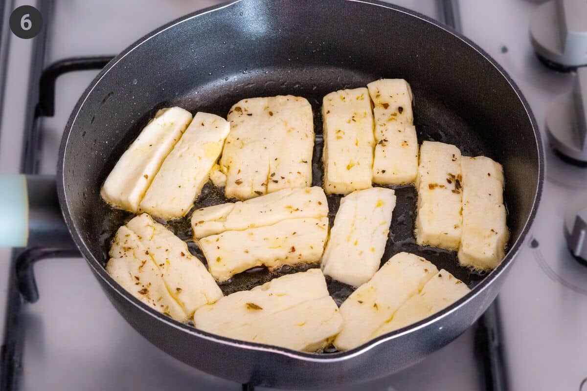 Halloumi pieces being pan fried