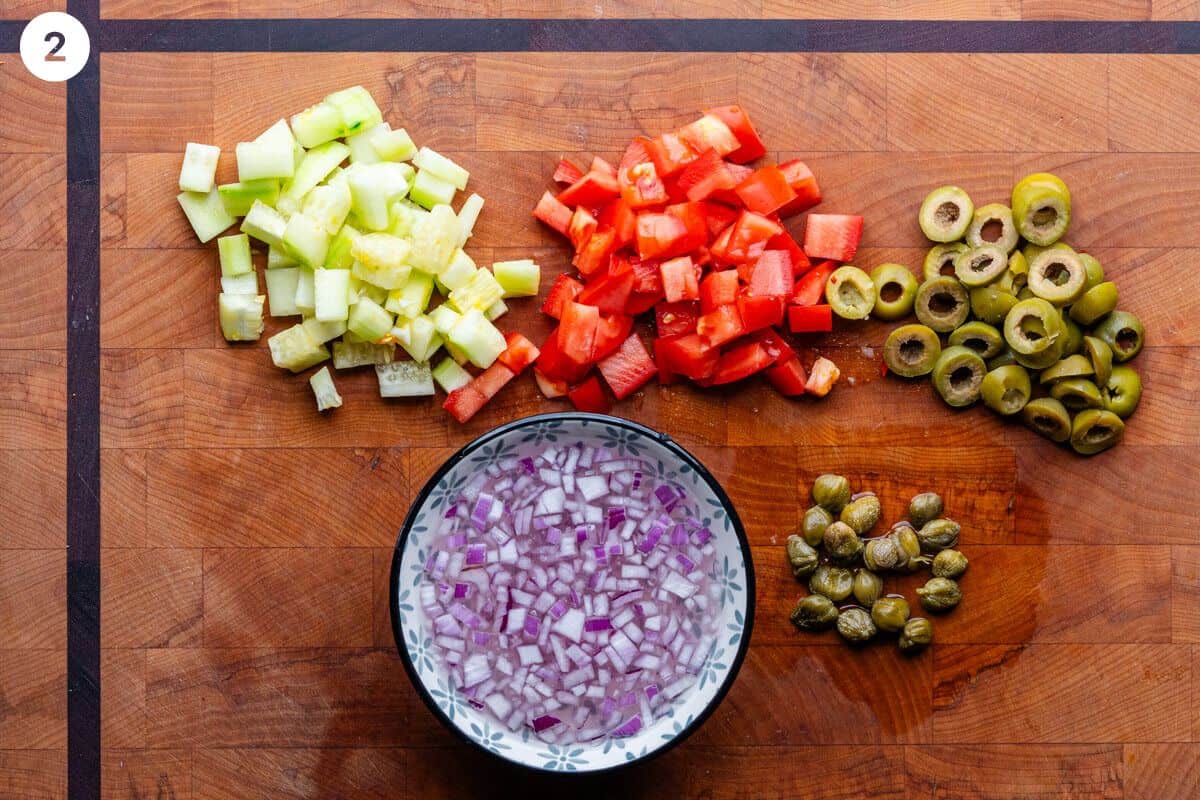 Salad ingredients chopped on a cutting board