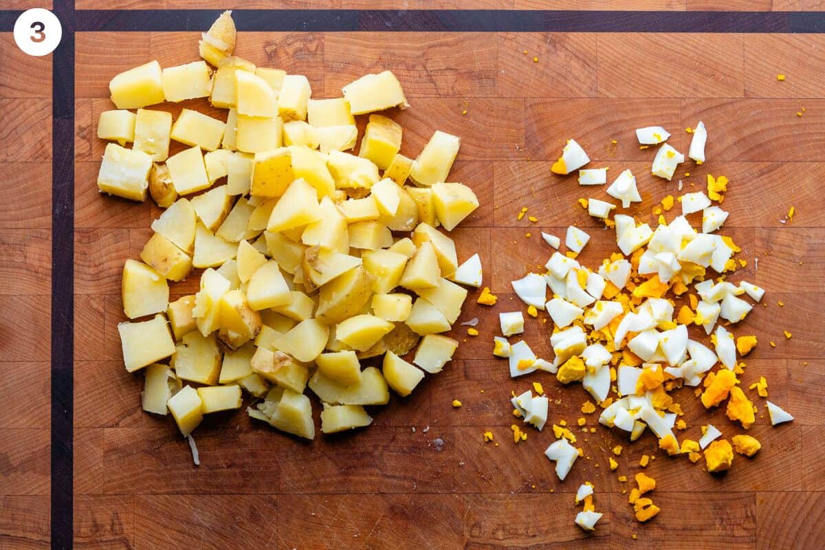 Potatoes and eggs diced on a cutting board