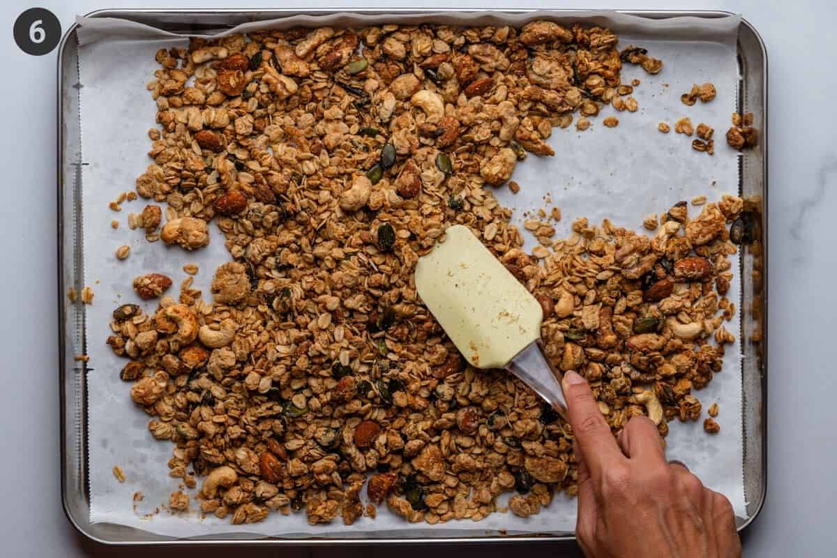 Granola mixture being mixed at the half way point of the cook