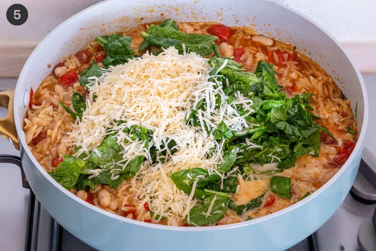 Spinach, parmesan and milk add to the pan