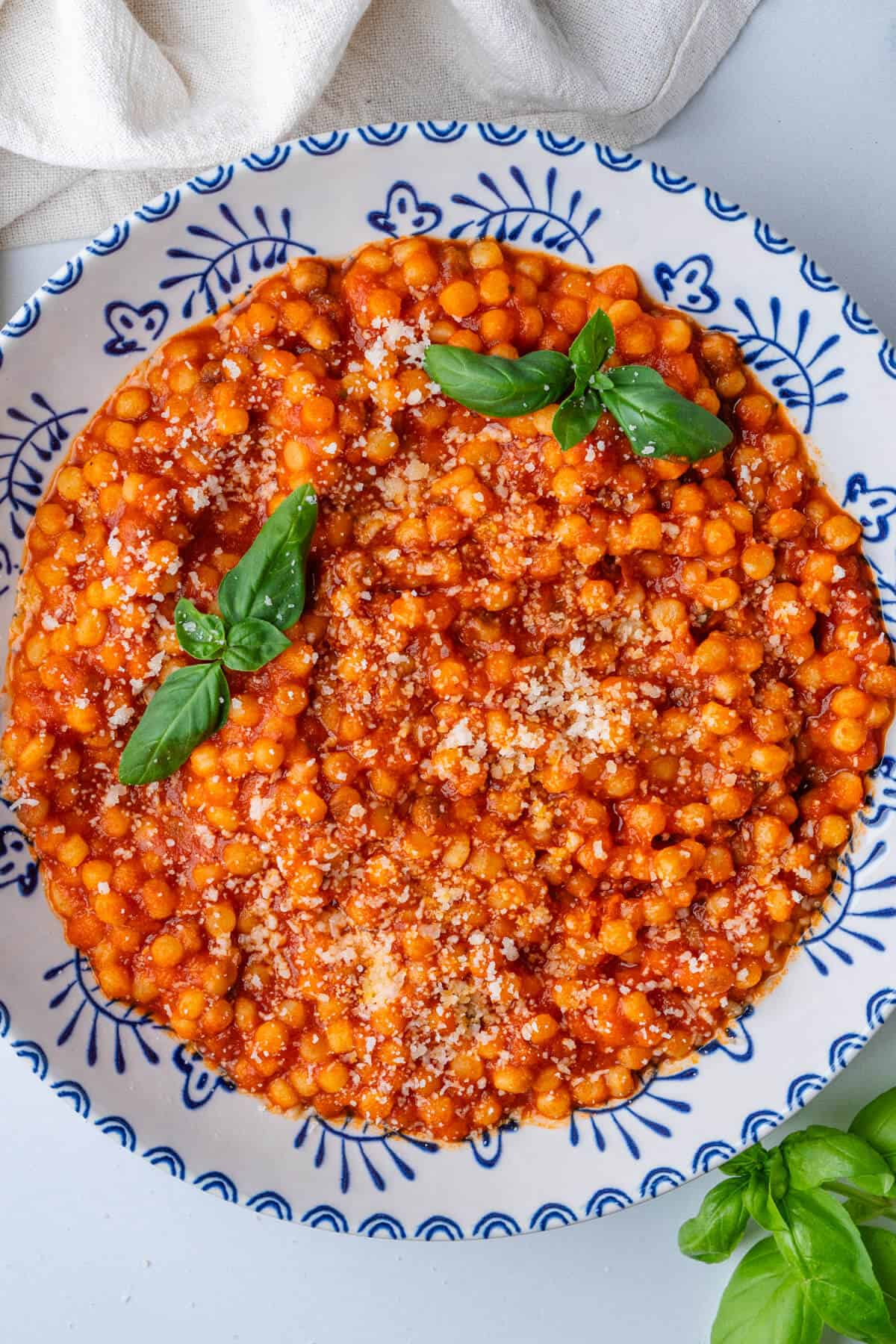 Bowl of fregula with tomato sauce