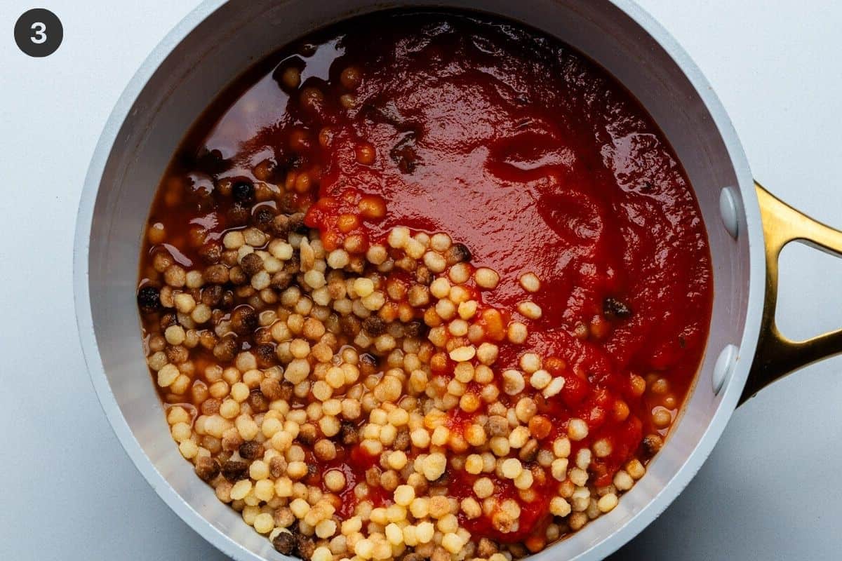 Pasta added to tomato sauce in a pot