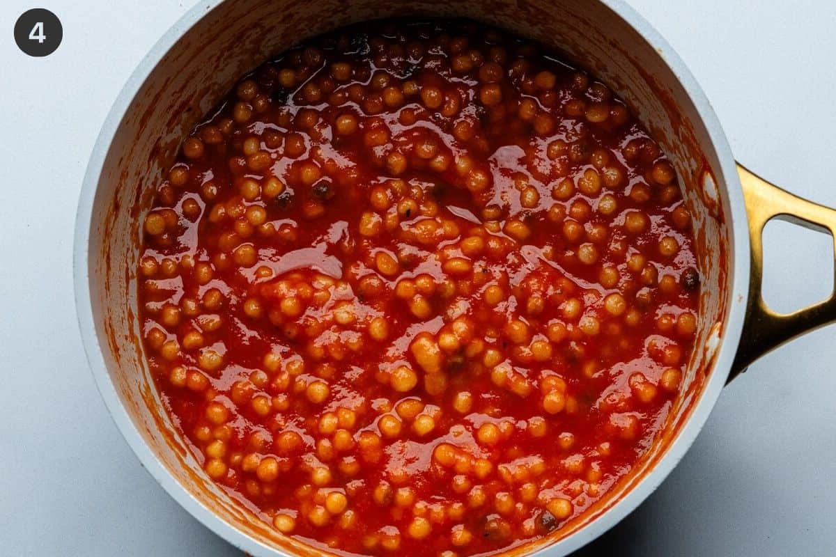 Pasta and tomato sauce mixed together in a pot