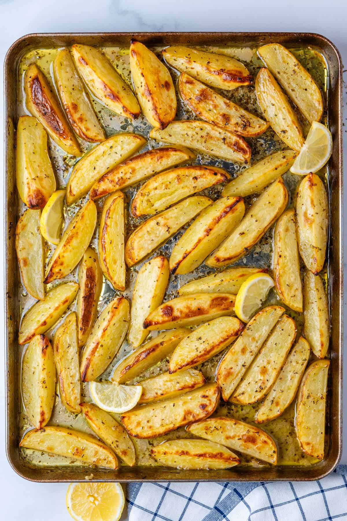 Baked Greek lemon potatoes on a baking tray