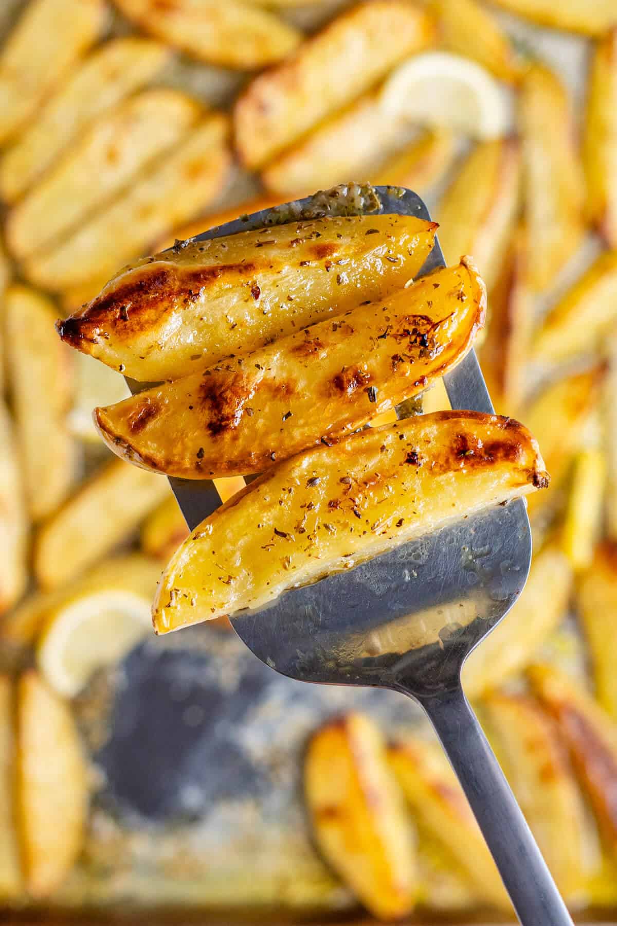 Close up of lemon potatoes on a spatula