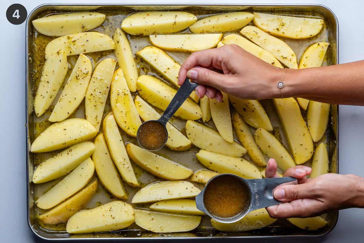 Broth being poured into gaps in the baking tray