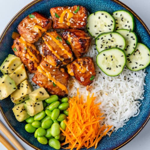 Salmon bowl with veggies, rice, avocado and edamame beans