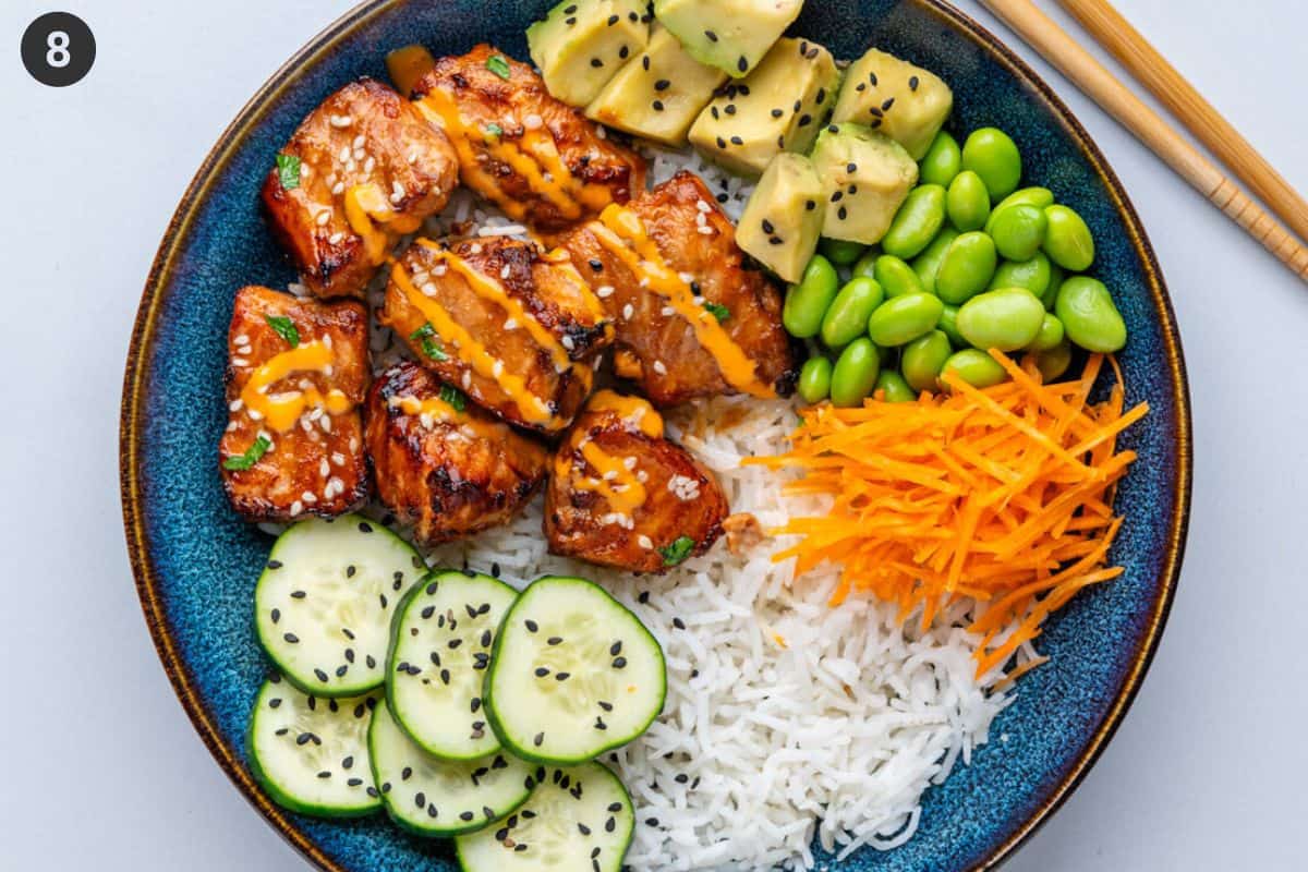 Final placement of ingredients to make a salmon bowl