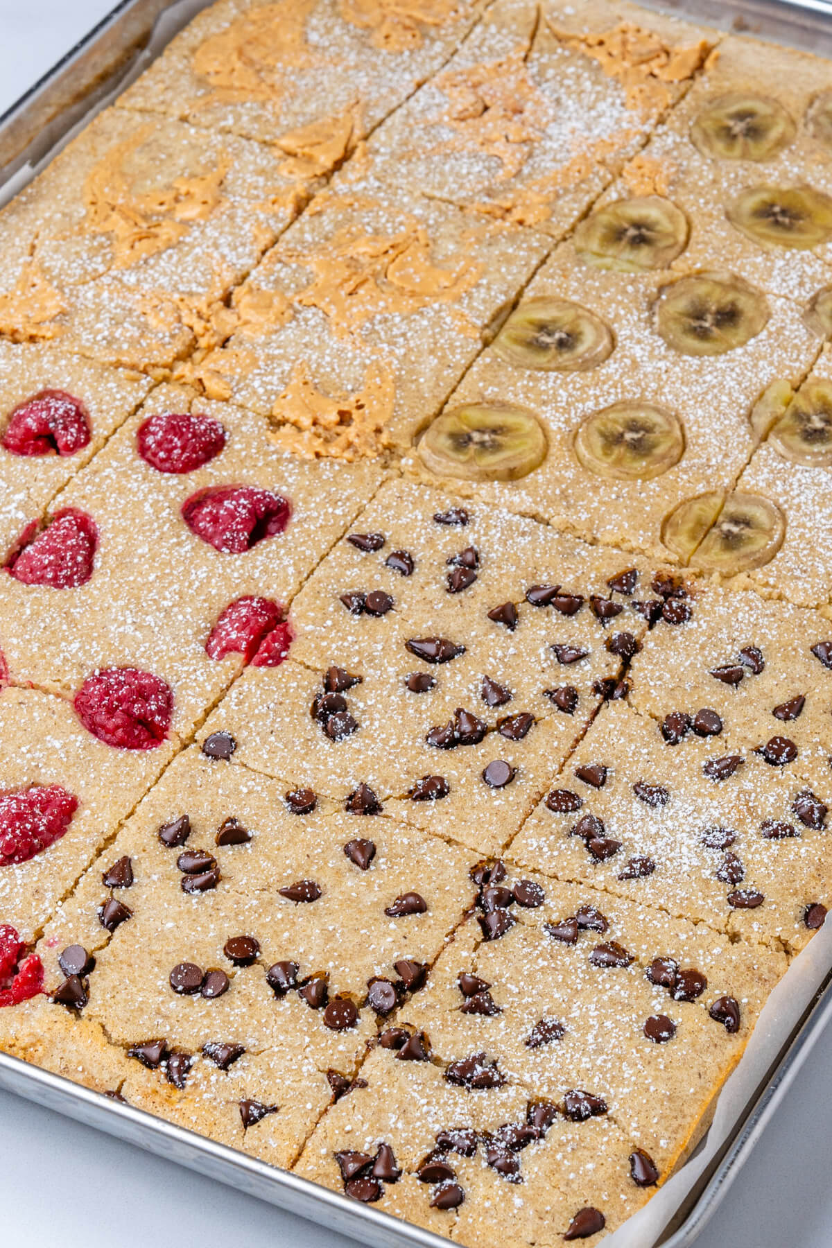 Angle shot of sheet pan pancakes with 4 toppings