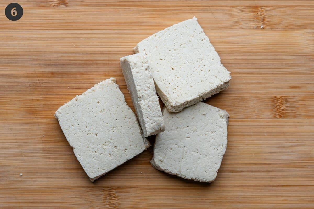 Tofu pieces sliced on a cutting board