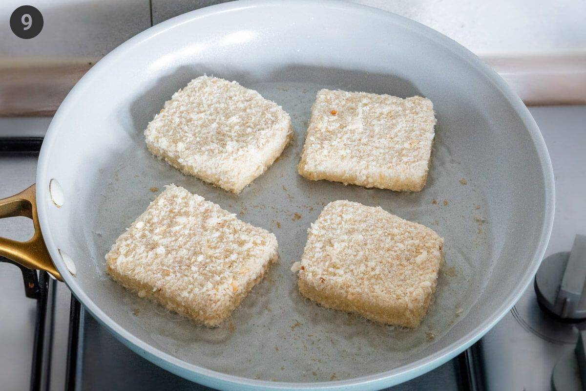 Crumbed tofu being pan fried