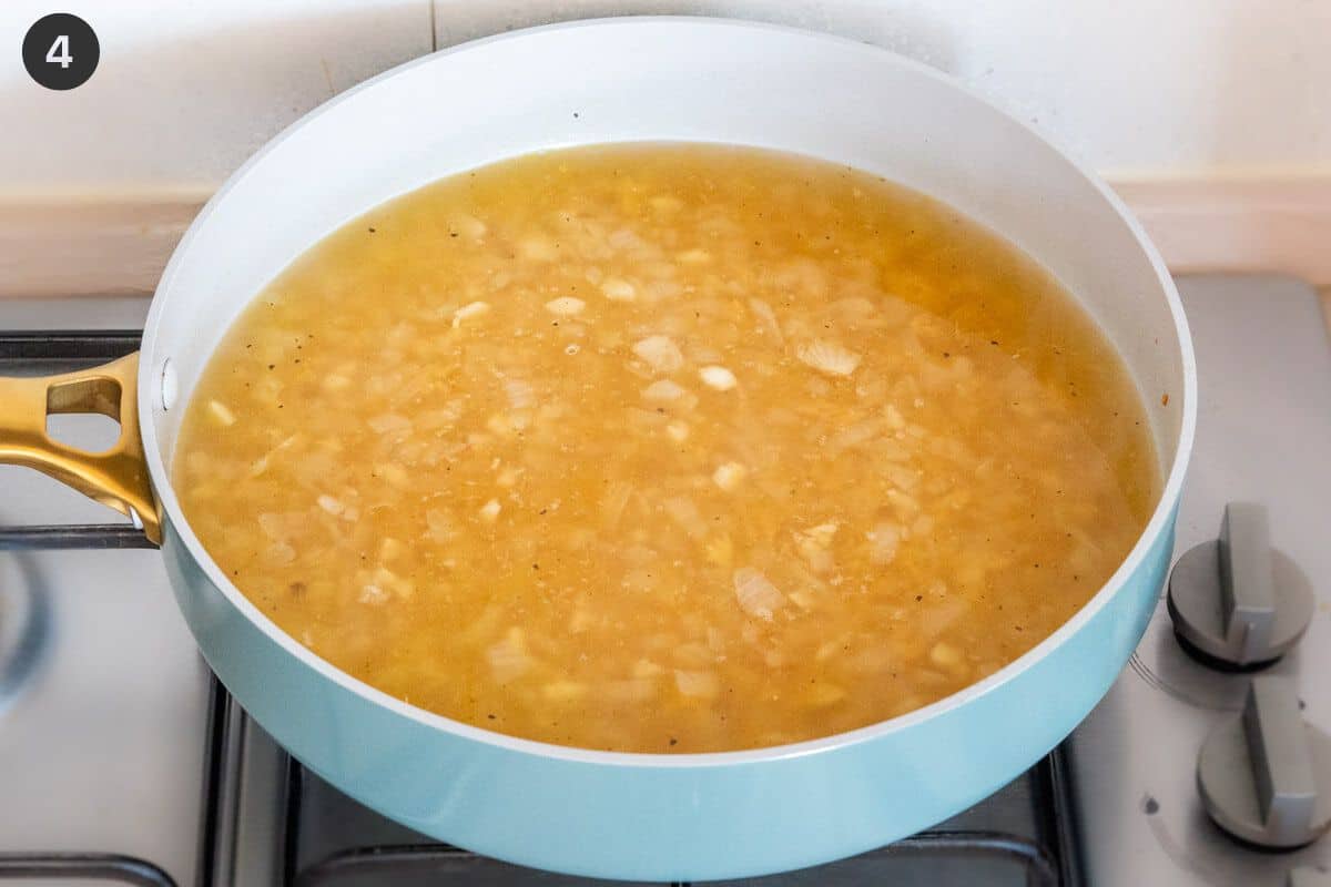 Broth and lemon juice added to pan