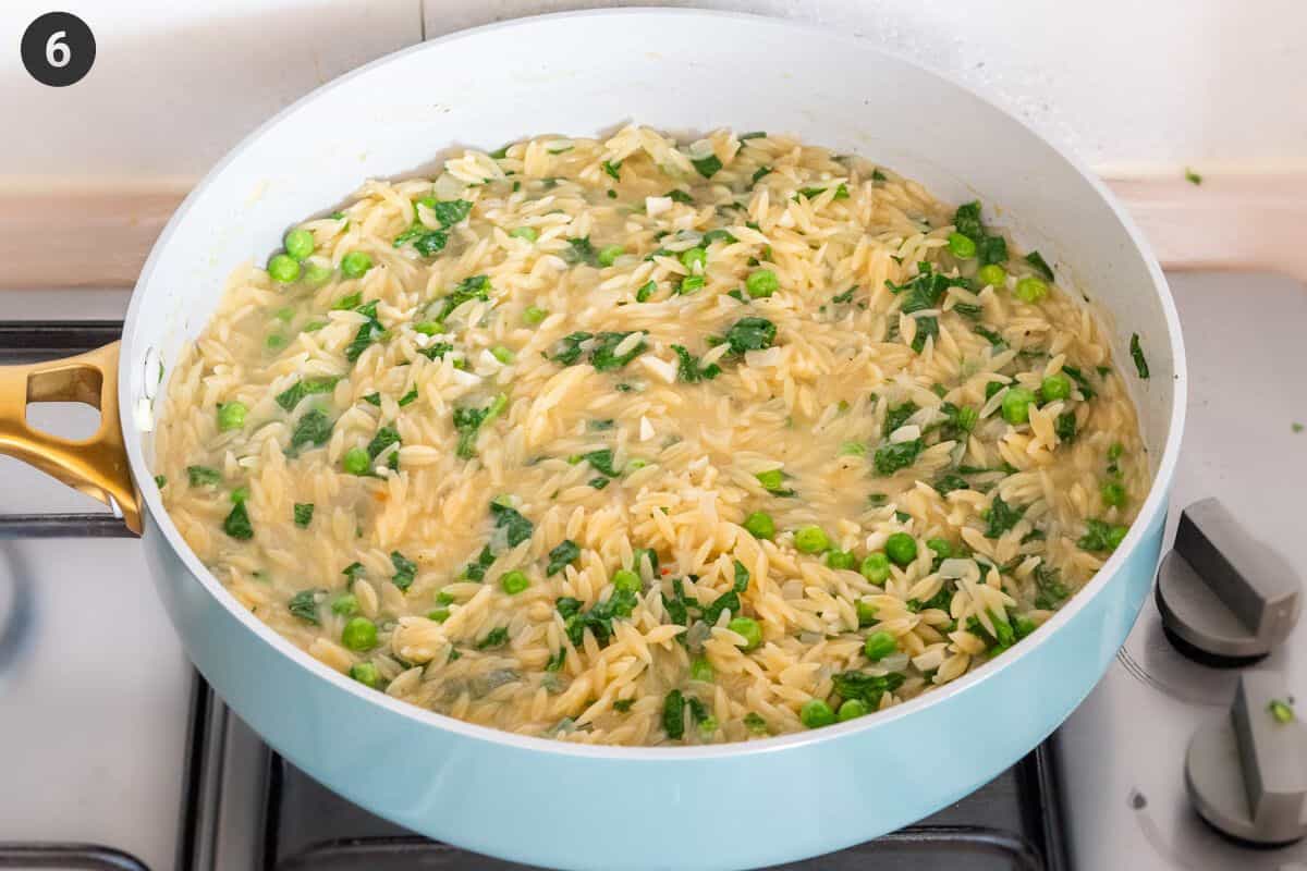 Final moments in cooking the orzo pasta in a pan