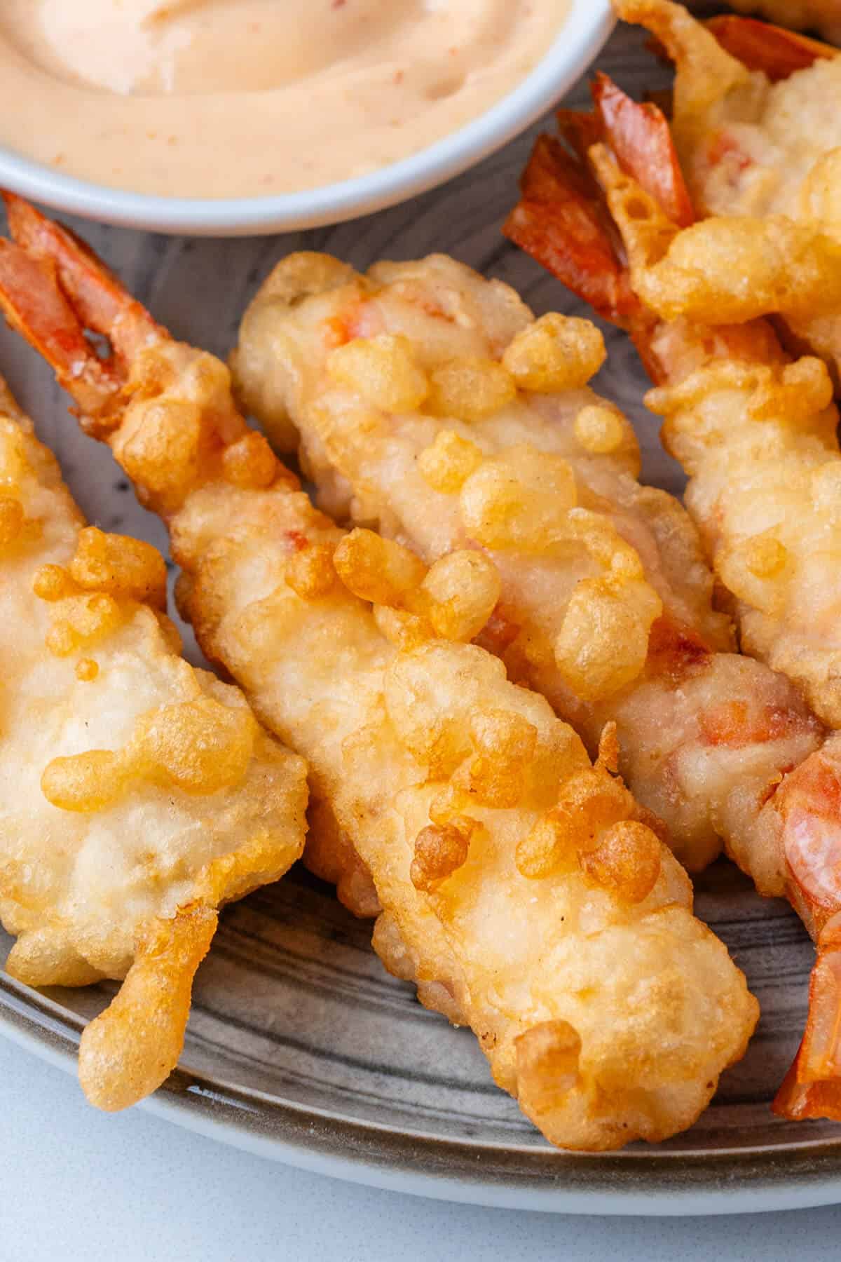 Focus on cooked shrimp tempura on a plate