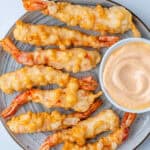 Shrimp tempura on a plate with sriracha aioli