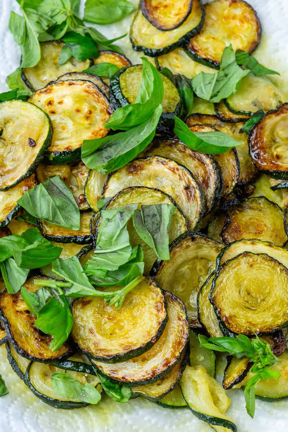 Fried zucchini with basil leaves on top