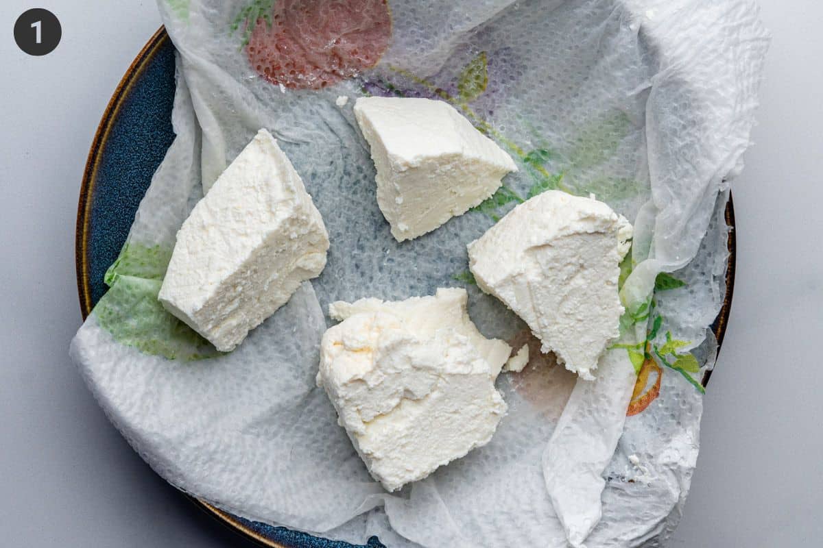 Fresh ricotta being drained on paper towels