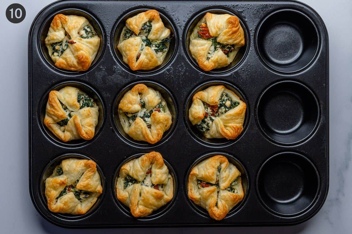 Spinach puffs fresh out of the oven in a muffin tin