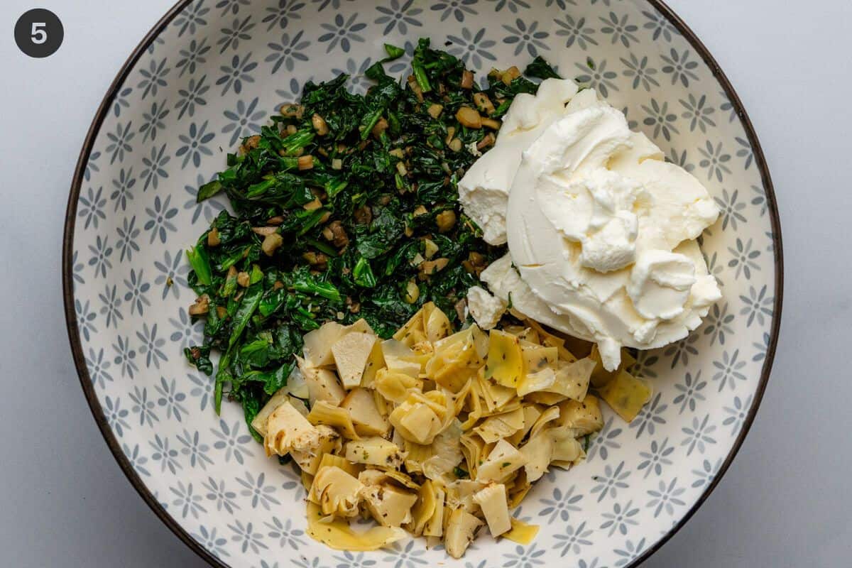 Spinach, artichoke and cream in a large bowl