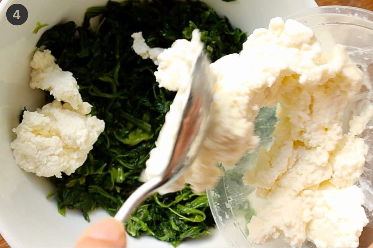 Ricotta being added to a bowl of spinach