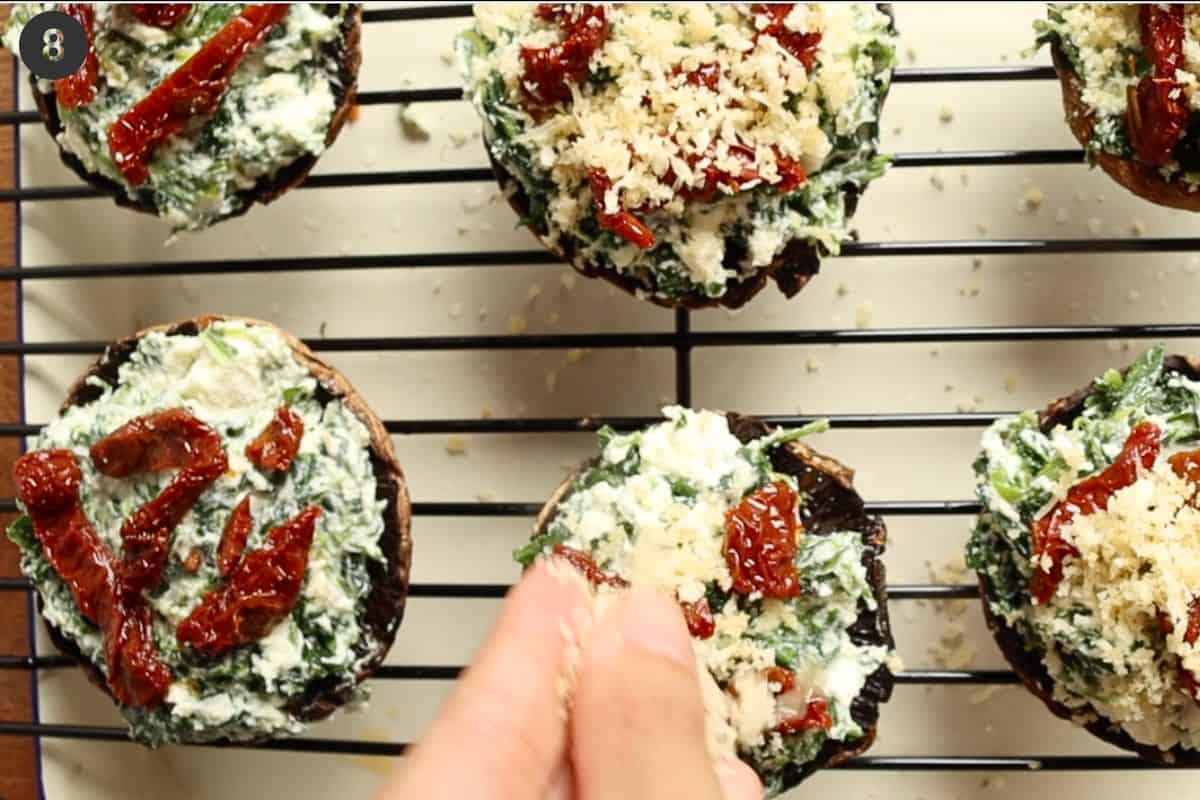 Sun dried tomatoes and breadcrumbs added to the top of mushrooms