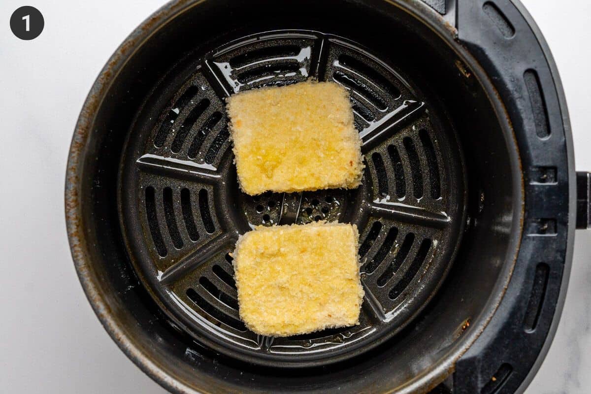 Tofu pieces being put in the air fryer