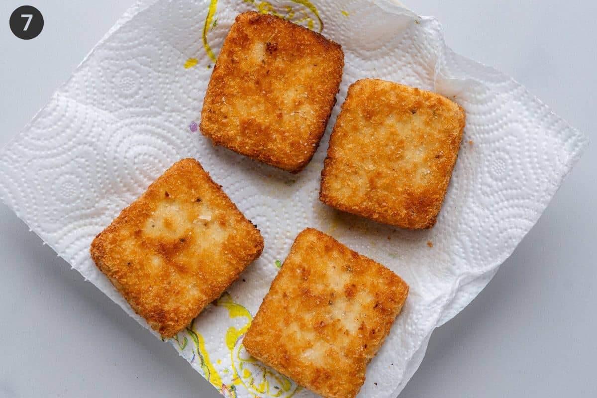 Cooked pieces of tofu on paper towels to remove excess oil