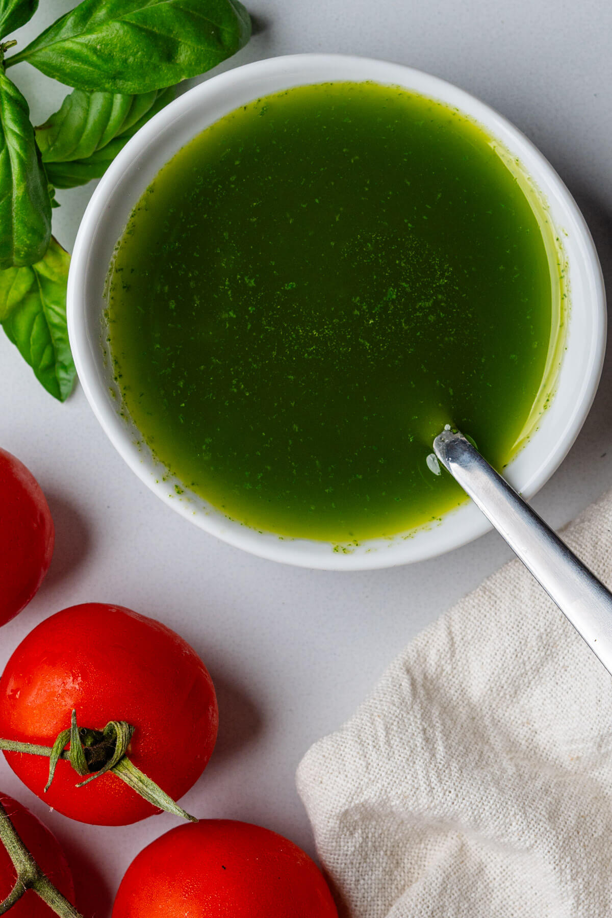 Spoon in a small bowl of basil oil