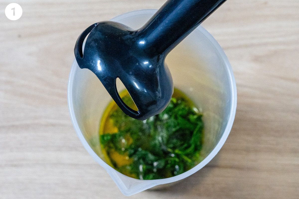 Blender stick about to blend basil with oil