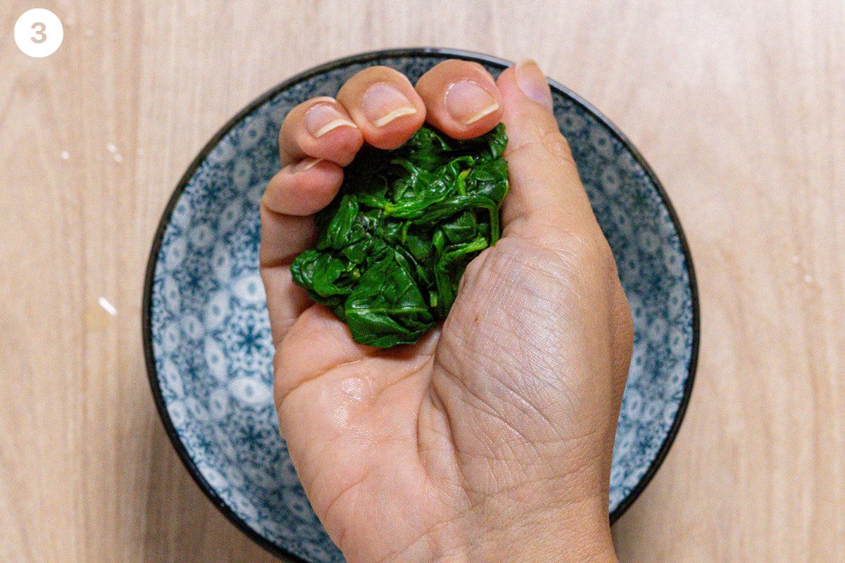 Liquid being squeezed out of basil