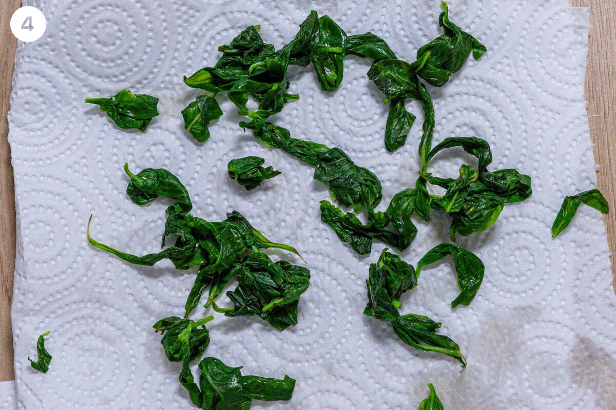 Basil being dried off with paper towels