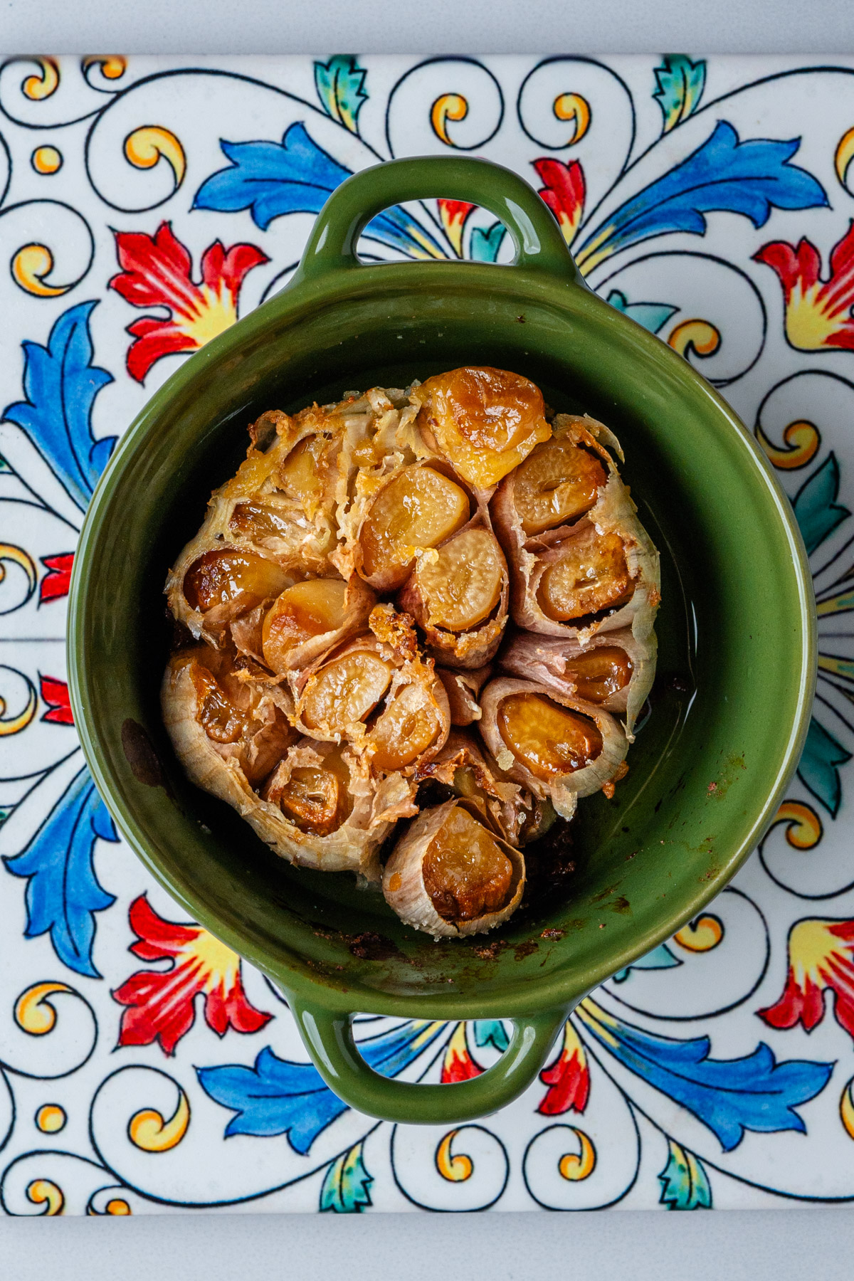 Roasted head of garlic in a small bowl