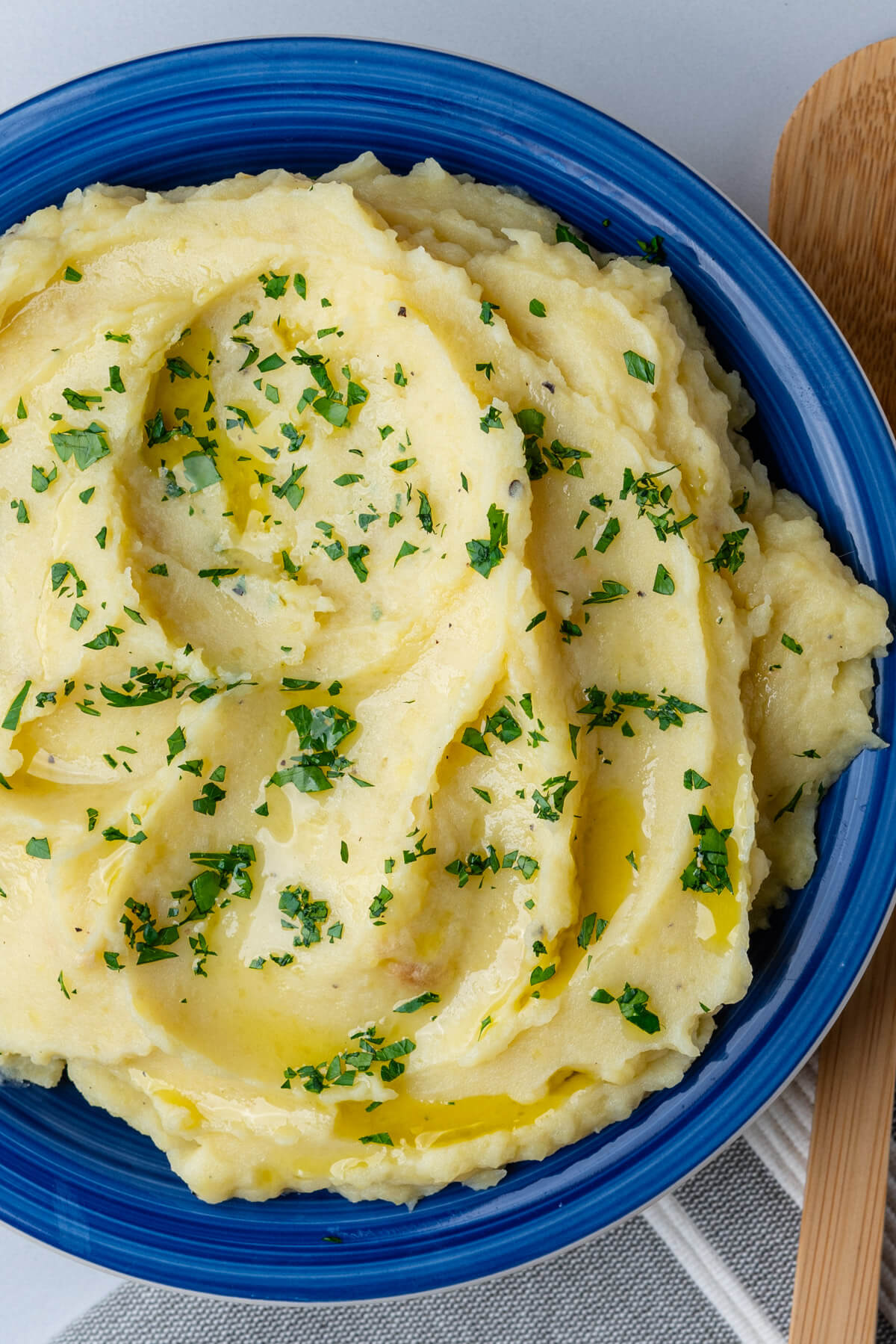 Garlic roasted mashed potatoes in a bowl topped with chopped parsley