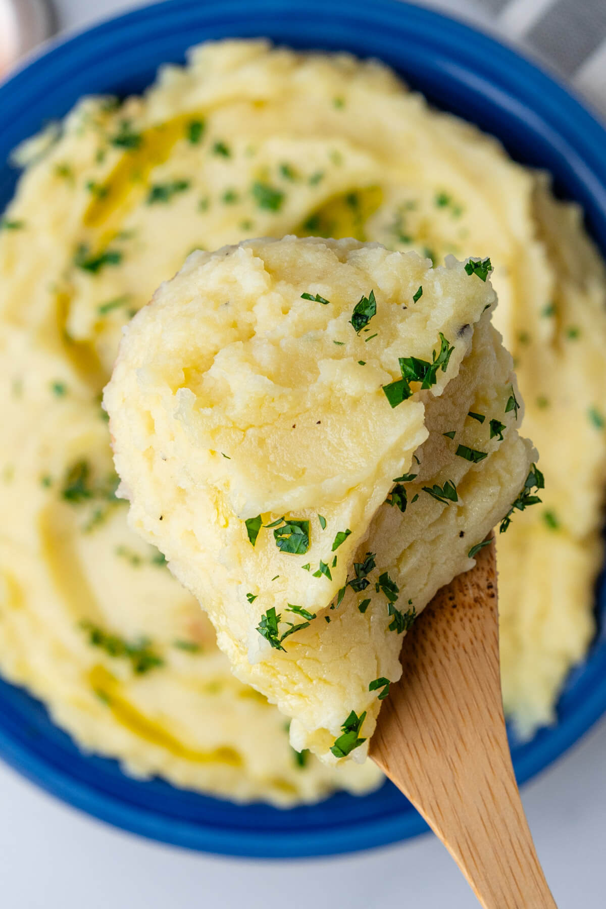 Close up of mashed potatoes on a wooden spoon