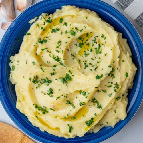 Garlic roasted mashed potatoes in a bowl with parsley